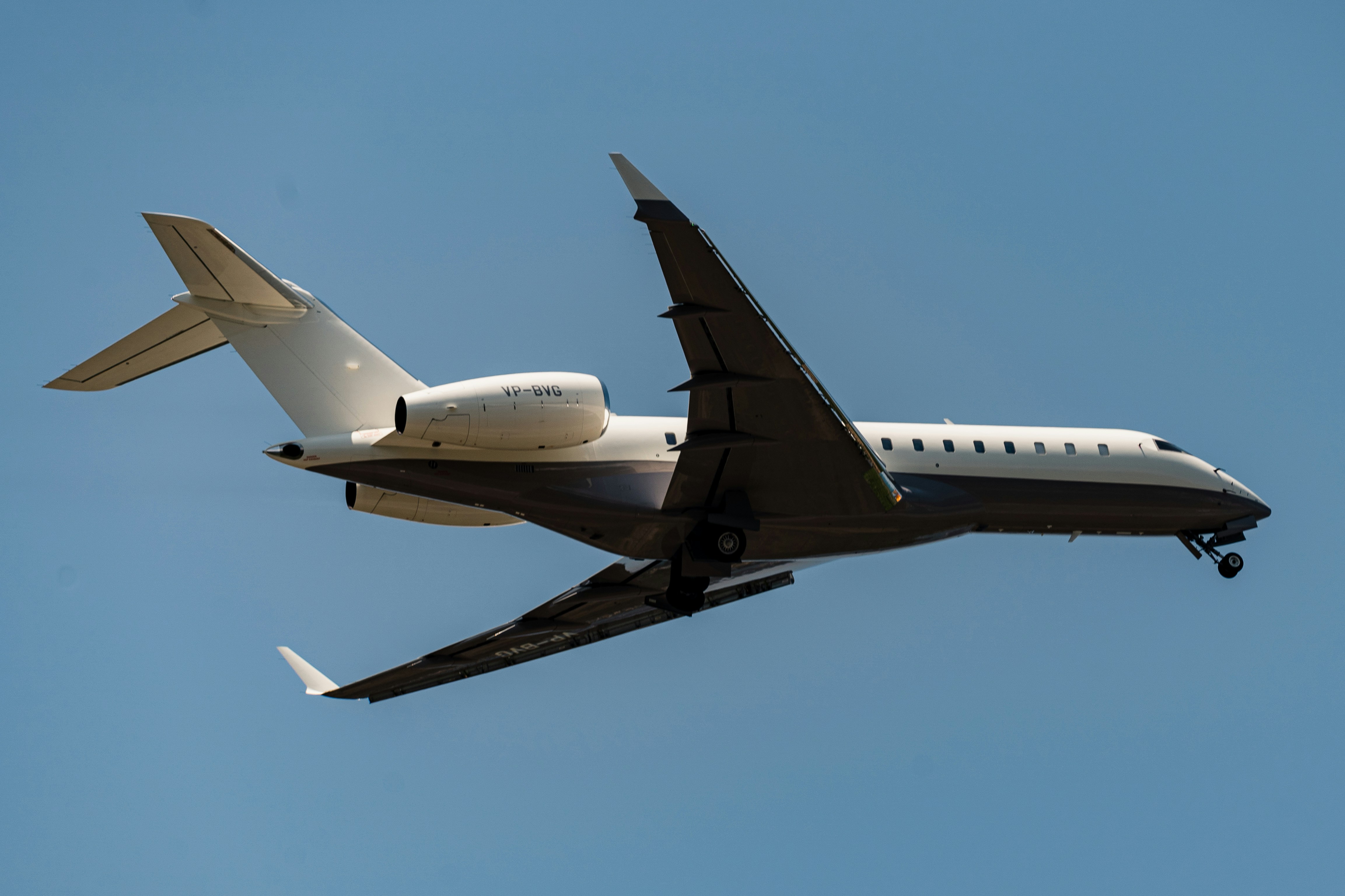 a large jetliner flying through a blue sky